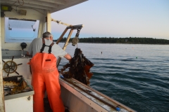 A man fishes for lobster off the coast of Maine with his wife.